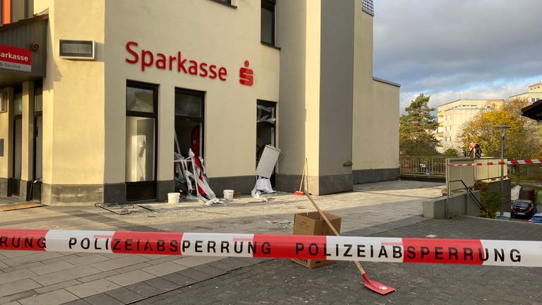 Zerstörte Fensterscheiben, eine Polizeiabsperrung vor einer Sparkasse in Koblenz